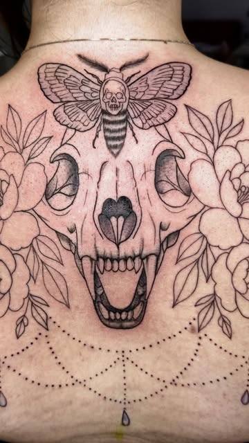Linework death-head moth over a skull and peonies with dotwork on the upper back