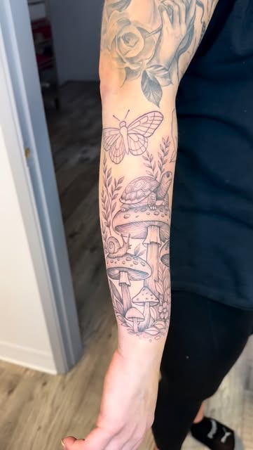 Forest sleeve in progress with mushrooms, butterfly and turtle on the forearm