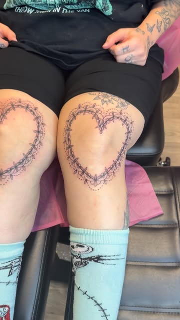 Matching lace heart tattoos on both knees