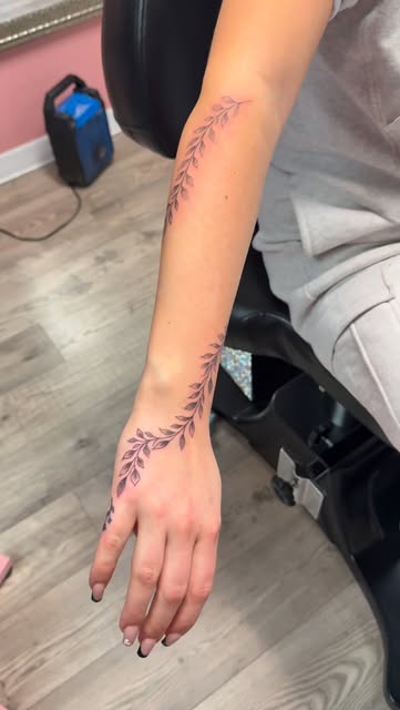Purple fine line vine wrapping the forearm and hand