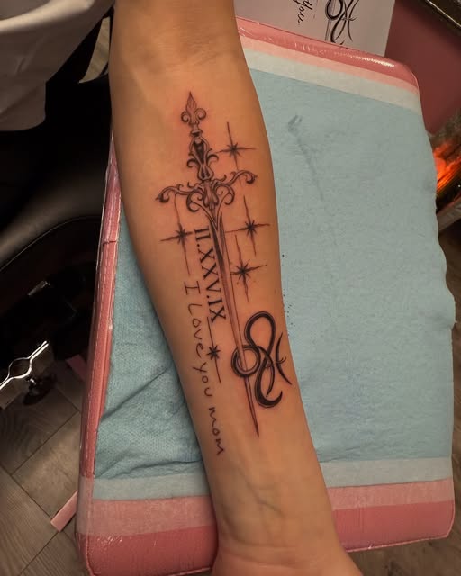 Dagger with Roman numerals and "I love you mom" script on the forearm