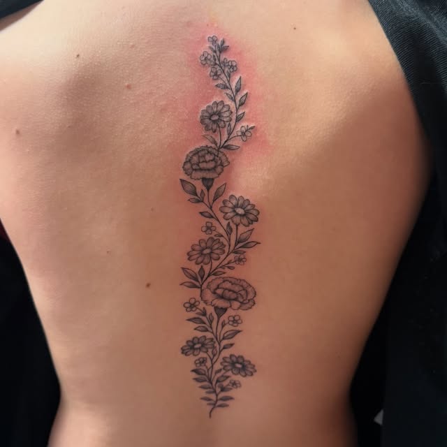 Fine line floral vine running down the spine