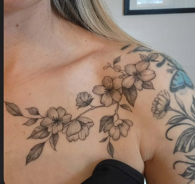 Healed fine line cherry blossoms over the collarbone and shoulder