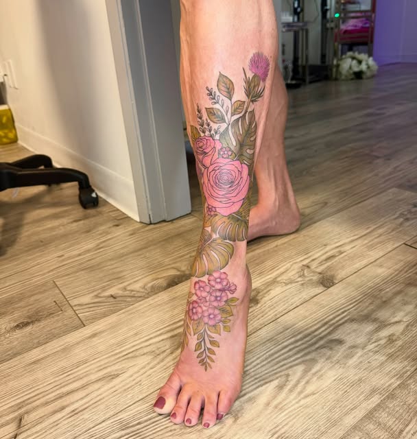 Pastel rose and leaf tattoo wrapping the ankle and foot