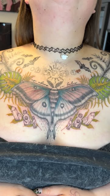 Colour luna moth with monstera, bats and botanicals across the chest