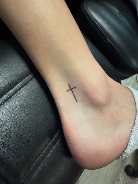 Tiny fine line cross on the ankle