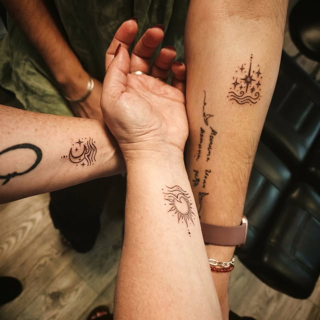 Matching celestial sun, moon and star tattoos on three forearms