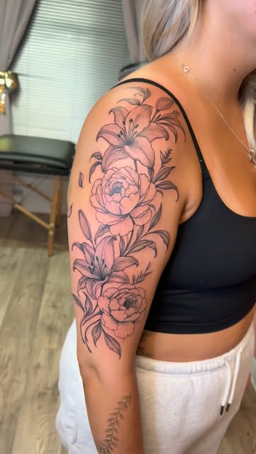 Lilies and peonies fine line piece over the shoulder and upper arm