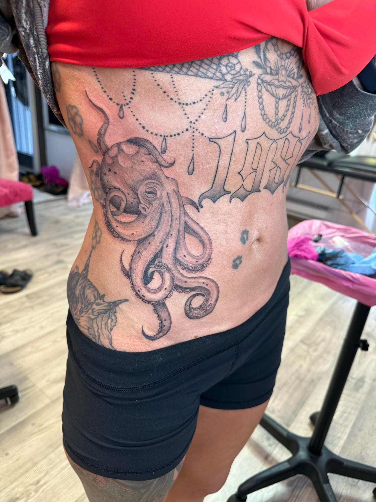 Octopus, ornate chandelier drops and script on the ribs and side