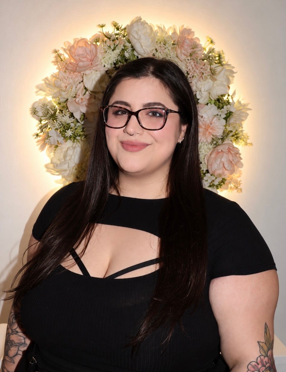 Portrait of Brynn Johnson in front of a flower wall at Glamour Gang Studio