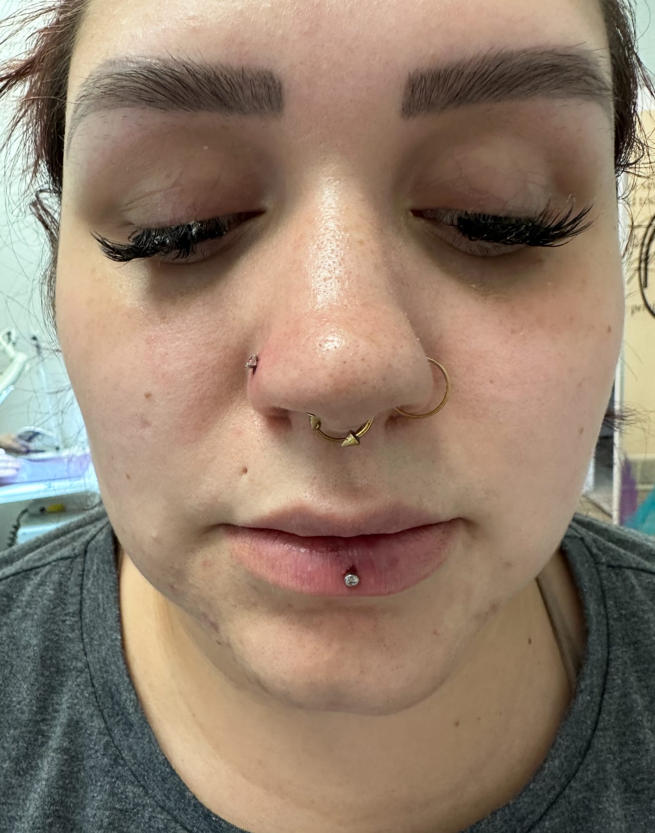Lip and nostril piercings by Shanda